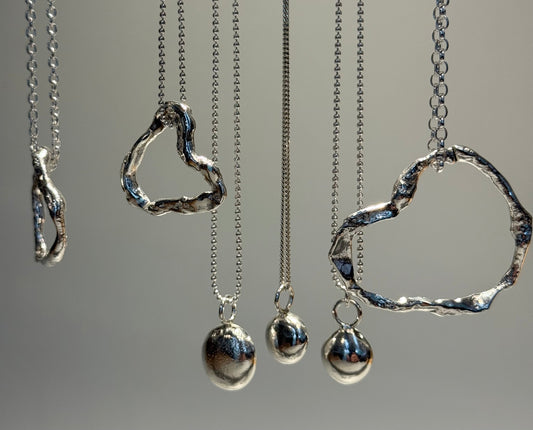 Molten hearts and pebbles on a chain. 
