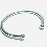 Solid Silver chunky torque bangle on a white background 